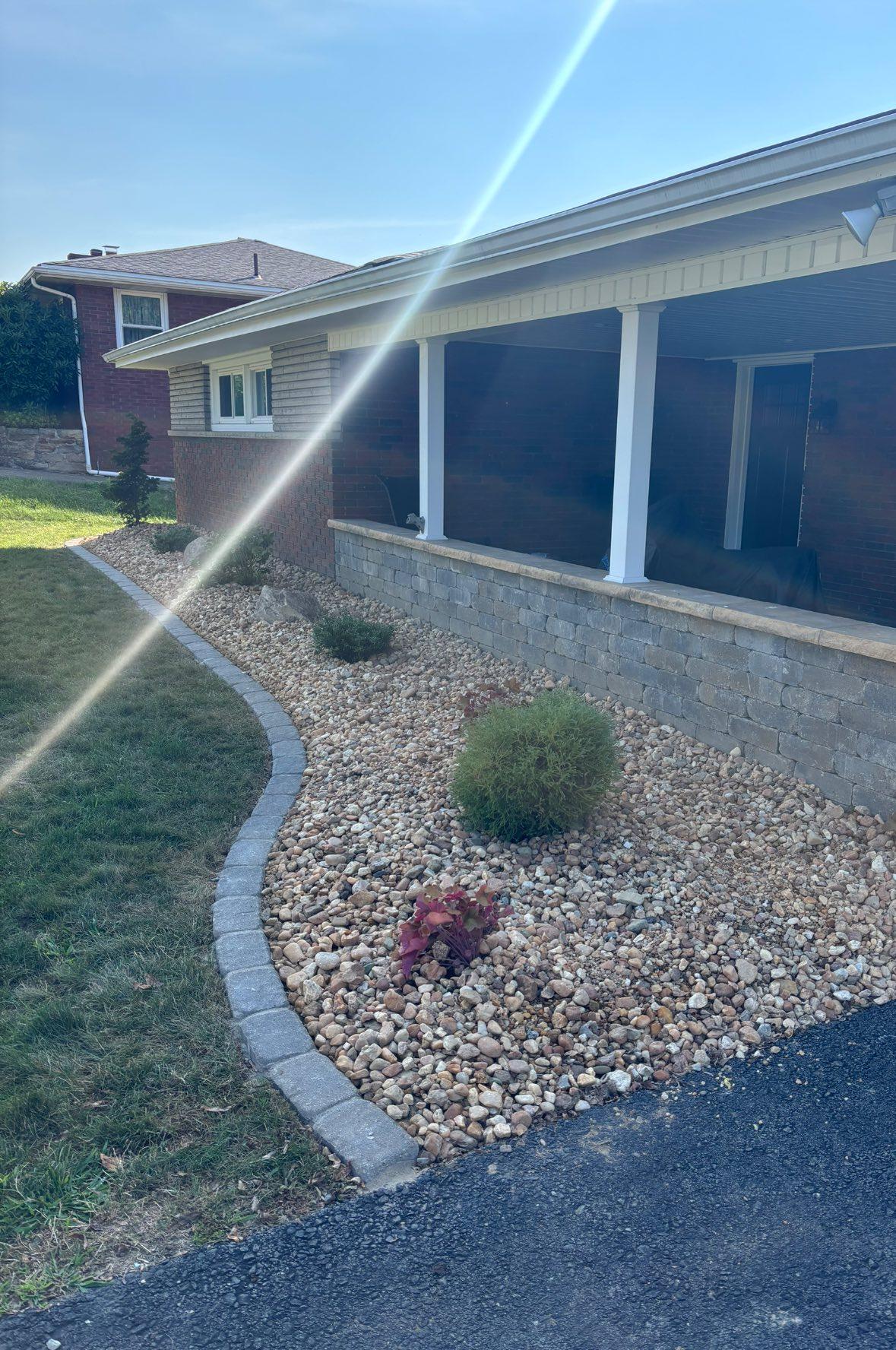 Same residential yard after mulch, edging, and landscape cleanup.